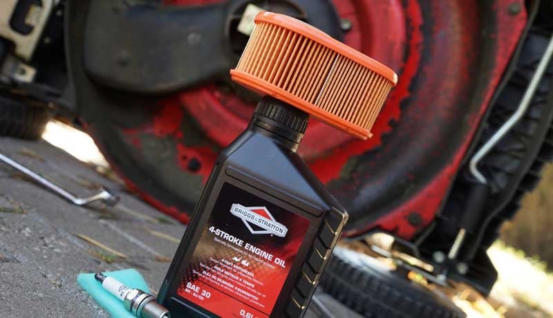 Orange oil filter on a Briggs & Stratton oil bottle.